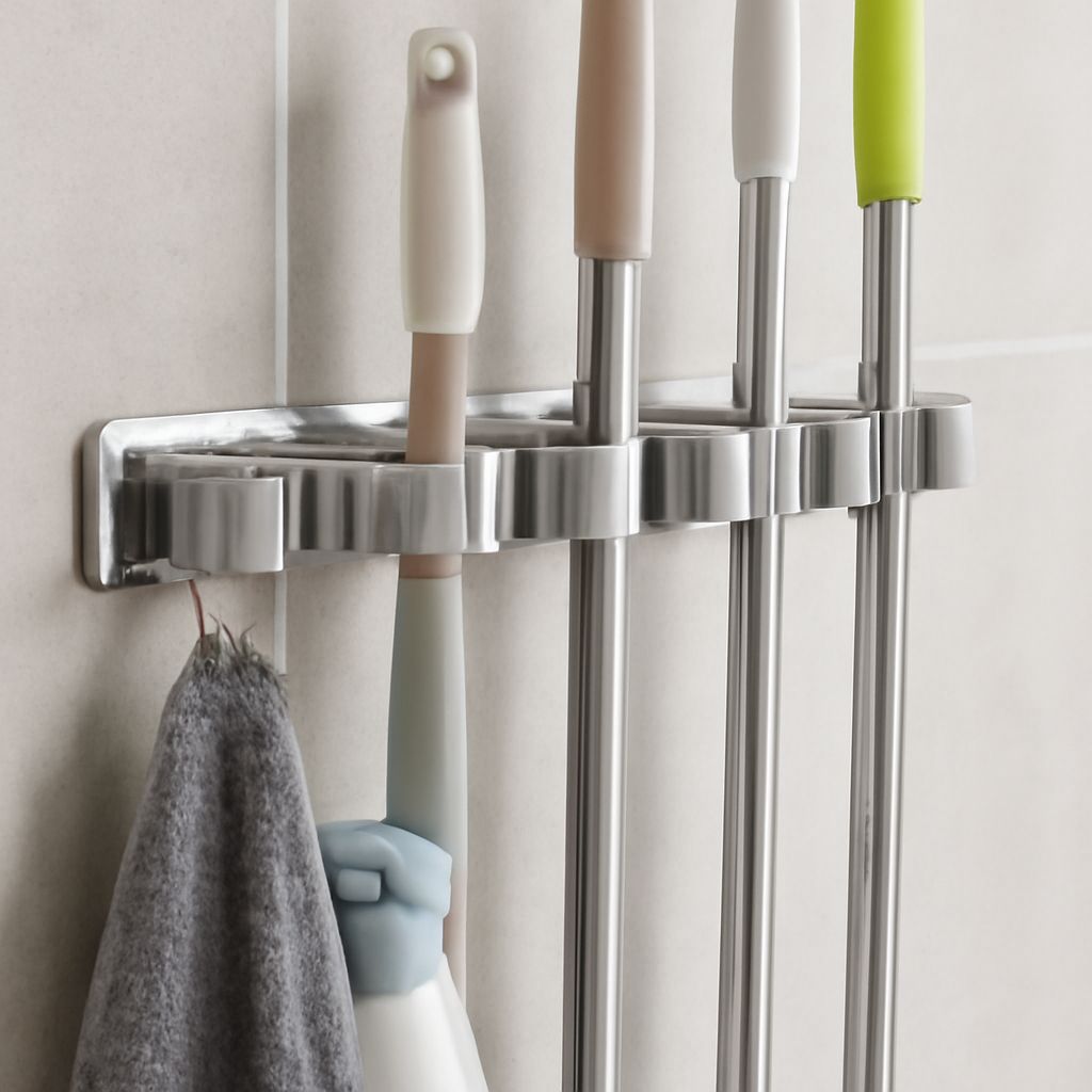 Wall-mounted mop and broom holder with clips and hooks